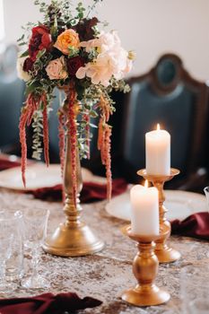 wedding table decoration with flowers on the table in the castle, table decor for dinner by candlelight.Dinner with candles.