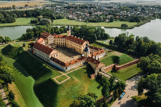 Aerial photo Nesvizh castle in autumn evening, Belarus Minsk, top view.