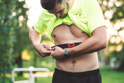 Fit man checking smart watch wearable technology sport smartwatch on workout outside. Man wearing smart watch during his training, measuring his activity. High quality photo