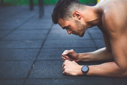 Fit man checking smart watch wearable technology sport smartwatch on workout outside. Man wearing smart watch during his training, measuring his activity. High quality photo