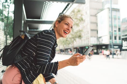 Beautiful caucasian woman living in the city. Woman spending her day in the city, sun is shining, weather is nice. Young millennial person living in the city, doing his daily errands.