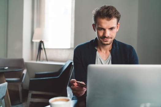 Beautiful caucasian man living in the city. Man spending his day in the city, sun is shining, weather is nice. Young millennial person living in the city, doing his daily errands always using his digital devices, tablet or phone.