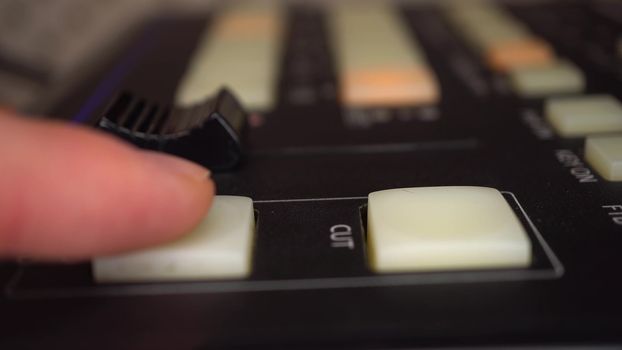 A video engineer operates a professional analog video mixer. Camera control panel. 4k