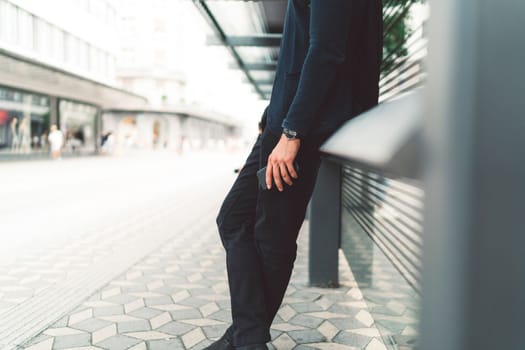 Beautiful caucasian man living in the city. Man spending his day in the city, sun is shining, weather is nice. Young millennial person living in the city, doing his daily errands always using his digital devices, tablet or phone.