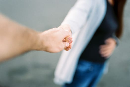 Man holds a woman hand. Cropped. High quality photo