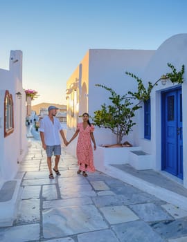 A couple walking at the village of Oia Santorini Greece, men and women visit the whitewashed Greek village of Oia during summer vacation