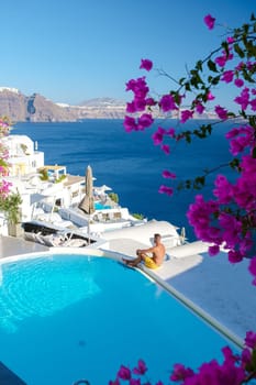 Couple on vacation in Santorini Greece, men and women visit the whitewashed Greek village of Oia during summer vacation