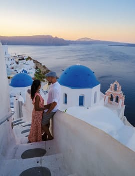 Couple on vacation in Santorini Greece, men and women visit the whitewashed Greek village of Oia during summer vacation on a sunny day