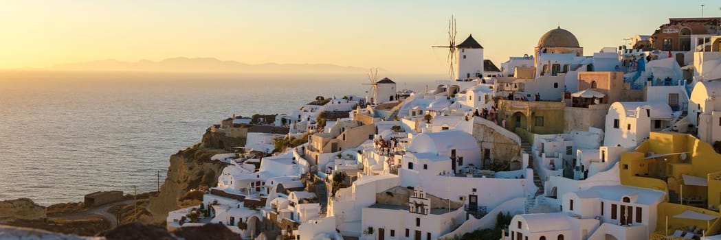 White churches and blue domes by the ocean of Oia Santorini Greece, a traditional Greek village in Santorini in the evening light