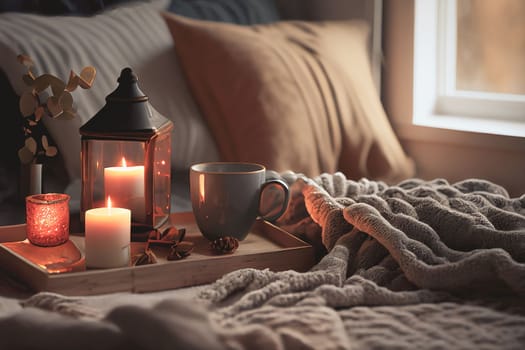 Cozy winter morning scene with hot coffee, blanket, candle lights, and heather and lavender flowers. Swedish concept of hygge is perfectly with copy space available for your own text.