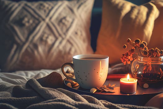 Cozy winter morning scene with hot coffee, blanket, candle lights, and heather and lavender flowers. Swedish concept of hygge is perfectly with copy space available for your own text.