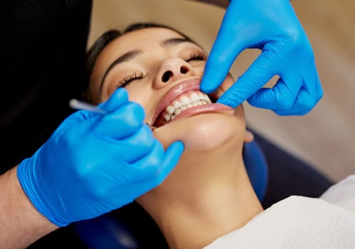 Get the smile you deserve. a young woman having a dental procedure performed on her
