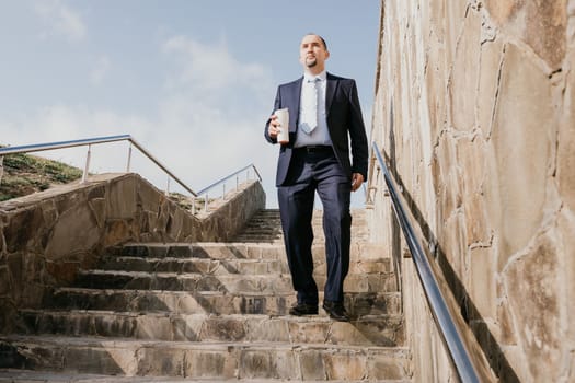 Business executive with briefcase going down the stairs.