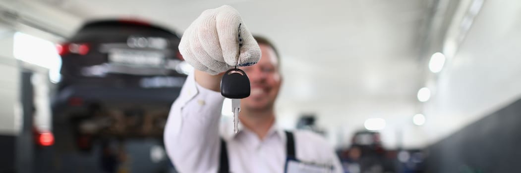 Auto mechanic holds clipboard and car keys. Quality auto repair services