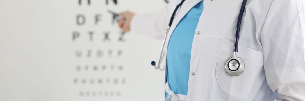 Ophthalmologist standing on background of table measuring vision closeup. Vision check in ophthalmological clinic