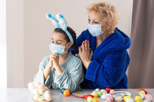 grandmother and granddaughter in masks for easter.