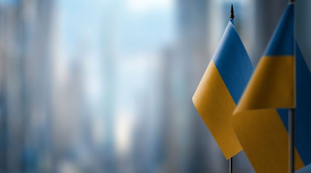 A small Ukraine flag on an abstract blurry background.