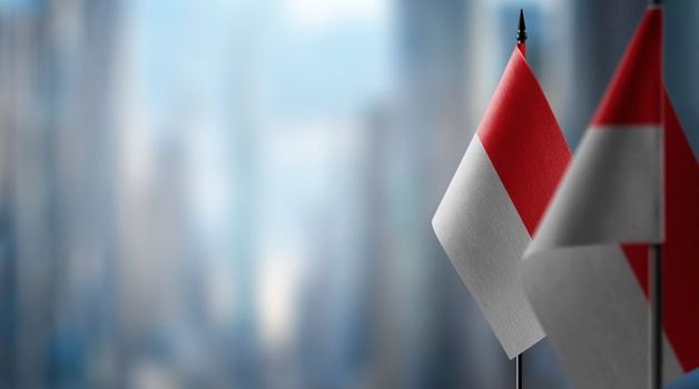 Small flags of the Indonesia on an abstract blurry background.