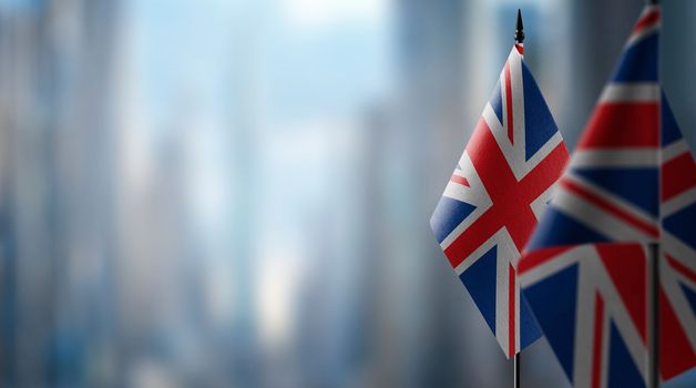 Small flags of the United Kingdom on an abstract blurry background.