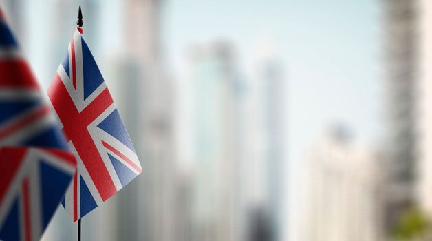 Small flags of the United Kingdom on an abstract blurry background.