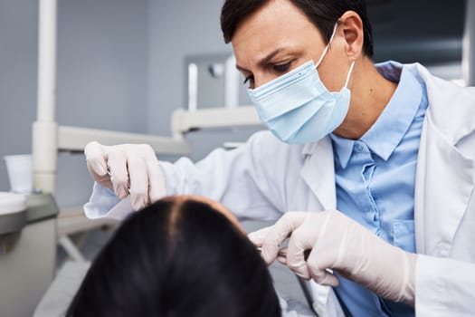 Theres still time to save your smile. a young woman having dental work done on her teeth