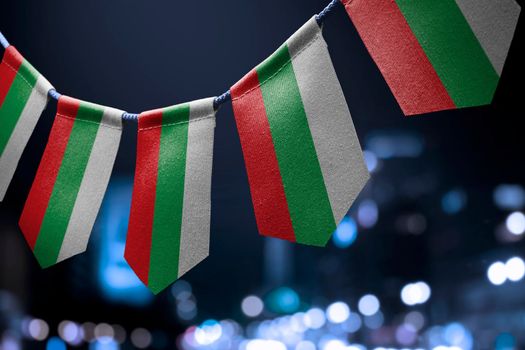 A garland of Bulgaria national flags on an abstract blurred background.