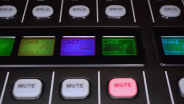 Panel of a professional digital audio mixer close-up. The camera makes a slide. 4k