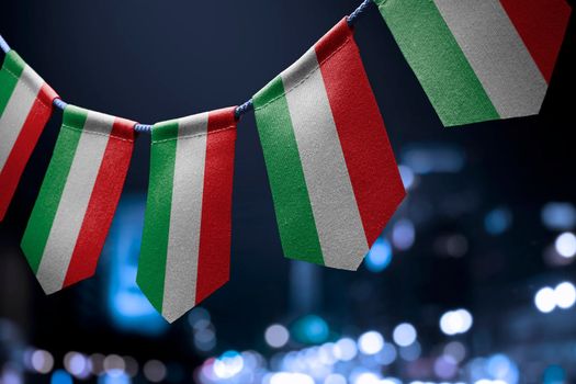 A garland of Hungary national flags on an abstract blurred background.