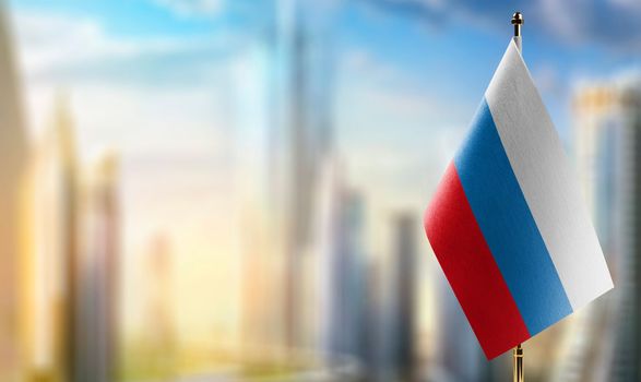Small flags of the Russia on an abstract blurry background.