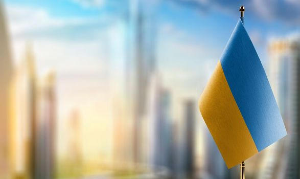 A small Ukraine flag on an abstract blurry background.