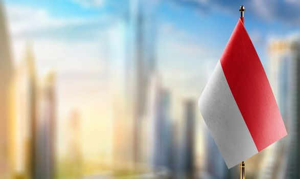 Small flags of the Indonesia on an abstract blurry background.