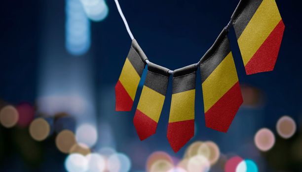 A garland of Belgium national flags on an abstract blurred background.