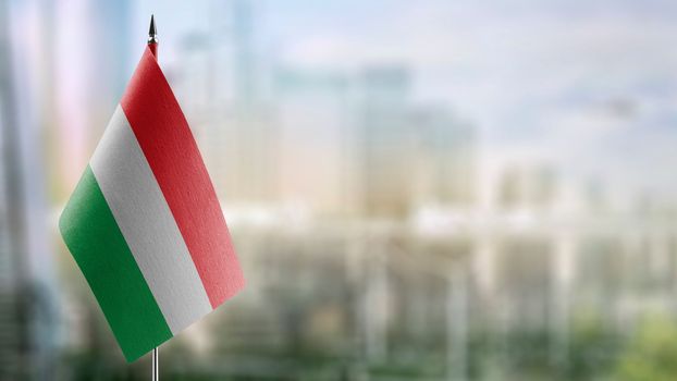 Small flags of the Hungary on an abstract blurry background.