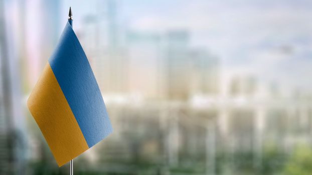 A small Ukraine flag on an abstract blurry background.