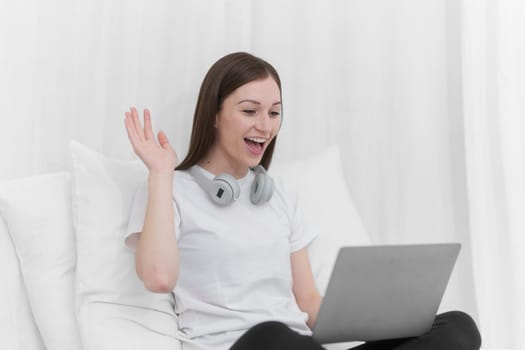 Image of beautiful young woman resting and watching movie in bed at bedroom. Lifestyle at home concept