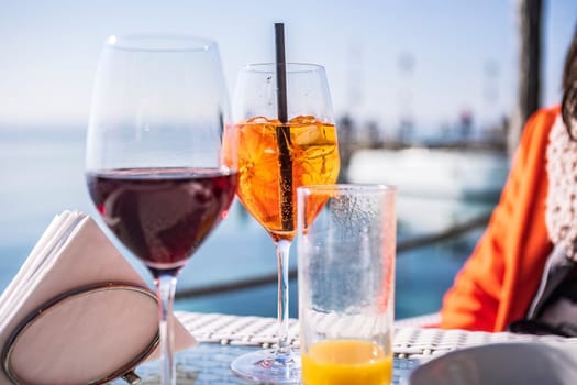 A luxurious bar setting on the Riviera, featuring exquisite glassware and a refreshing drink on a sleek bar table.