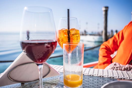 A luxurious bar setting on the Riviera, featuring exquisite glassware and a refreshing drink on a sleek bar table.