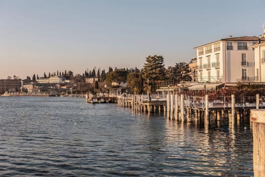 Capture the beauty of Sirmione's sunset with this stunning landscape photo. The vibrant colors and serene atmosphere make for a perfect wall art or background for any project