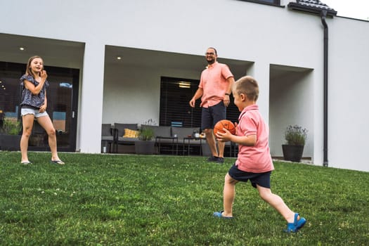 Happy caucasian family of four, mother father and children at home, outdoors playing on the grass, and indoors in the living room having fun as a family.