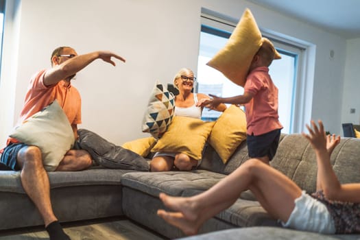 Happy caucasian family of four, mother father and children at home, outdoors playing on the grass, and indoors in the living room having fun as a family.