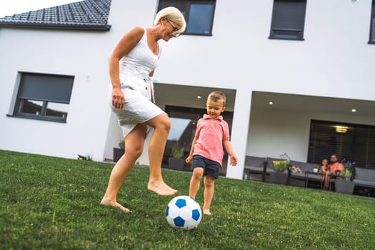 Happy caucasian family of four, mother father and children at home, outdoors playing on the grass, and indoors in the living room having fun as a family.