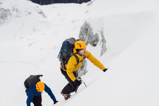 Mountaineer backcountry ski touring in the mountains. Ski touring in high alpine landscape with snowy trees. Adventure winter extreme sport. High quality photo