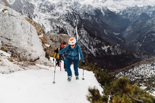 Mountaineer backcountry ski touring in the mountains. Ski touring in high alpine landscape with snowy trees. Adventure winter extreme sport. High quality photo