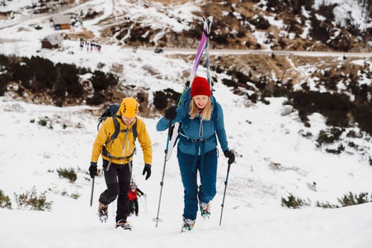 Mountaineer backcountry ski touring in the mountains. Ski touring in high alpine landscape with snowy trees. Adventure winter extreme sport. High quality photo