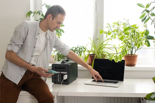 a man uses a portable charging station.