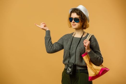 Tourist woman in summer casual clothes, hat doing selfie shot on mobile phone isolated on yellow orange background. Female passenger traveling abroad to travel on weekends getaway. Air flight concept