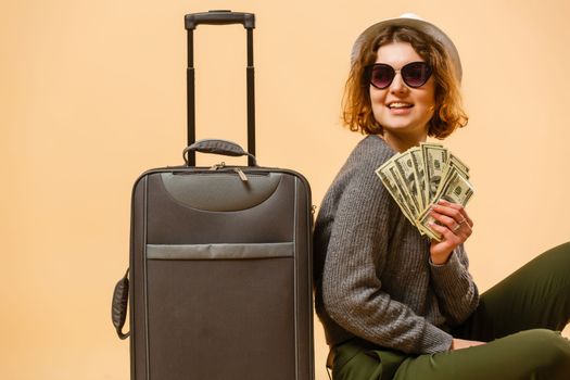 Close up tourist woman in summer casual clothes, hat at suitcase passport cash money isolated on yellow background. Passenger traveling abroad to travel on weekends getaway. Air flight concept