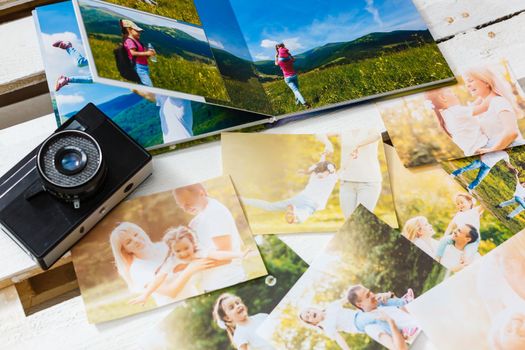 printed photos of family summer vacation lying on desk