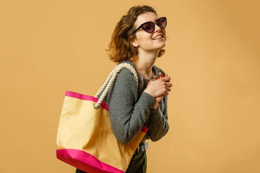 Traveler tourist woman in summer casual clothes, hat with suitcase isolated on yellow orange background. Female passenger traveling abroad to travel on weekends getaway. Air flight journey concept
