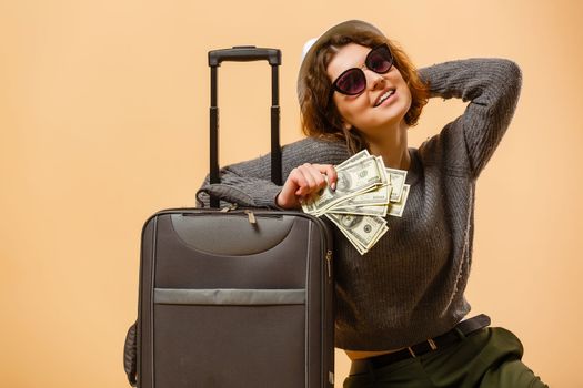 Close up tourist woman in summer casual clothes, hat at suitcase passport cash money isolated on yellow background. Passenger traveling abroad to travel on weekends getaway. Air flight concept